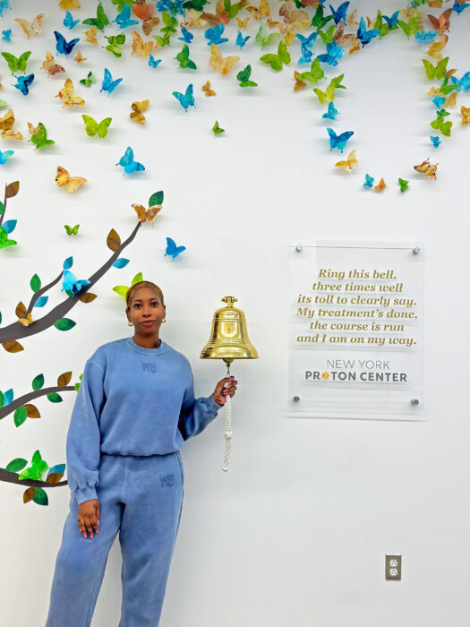 Shenae Craig rings the bell after completing cancer treatment.