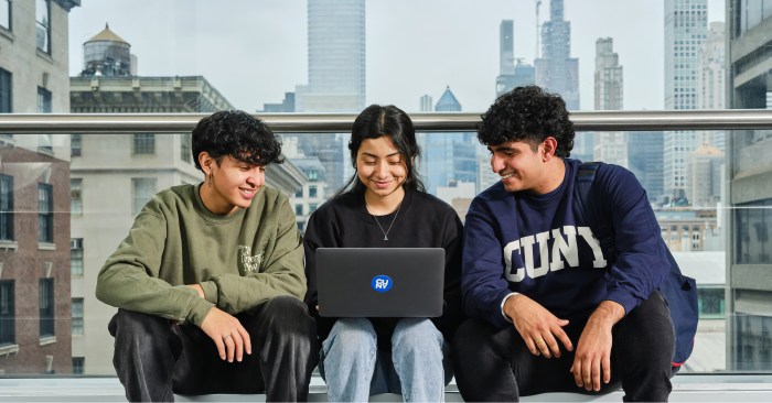 Students of Hunter College gather around a laptop.