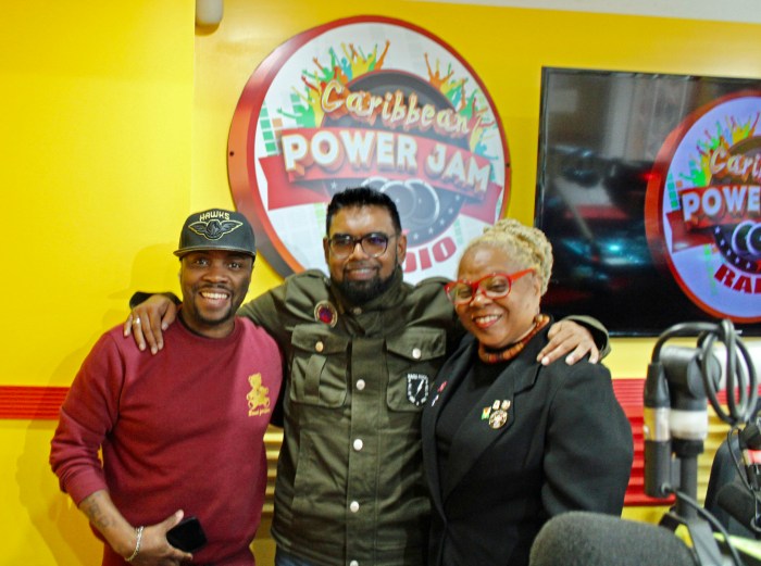 Guyanese owner of Caribbean PowerJam Radio, Shoan Sampson on Remsen Avenue in Brooklyn left, gets a hug from President Ali, center, and Lady Linda Felix Johnson after an interview at the Brooklyn-based station on April 19.