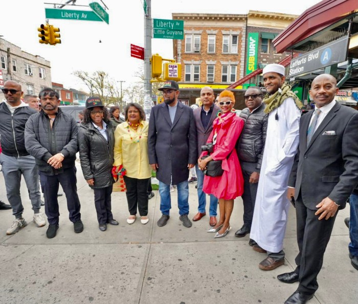 Guyanese nationals from Brooklyn and Queens joined President Irfaan Ali for a photo-op under the Little Guyana sign at the intersection of Lefferts Boulevard and Liberty Avenue in Richmond Hill, Queens, during his final stop of a walkabout in New York, on April 19.