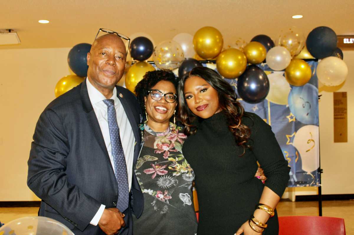 Captain Eric Bramwell, wife Grace, and daughter, Ericia, against a backdrop that says ‘Farewell,’ during a gathering on March 28, at the United Nations Headquarters, to wish the security officer a happy retirement after 36 1/2 years of service.