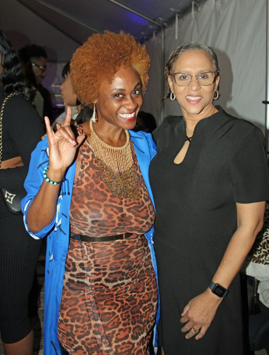 A supporter, left, joins Bartenura Wines Brand Ambassador, Guyanese-American CEO/Owner of JAP MarketingLLC, June Persaud, to celebrate the opening of up-scale restaurant Le Chai Asian Flare, at 1904 Utica Ave., in Brooklyn.