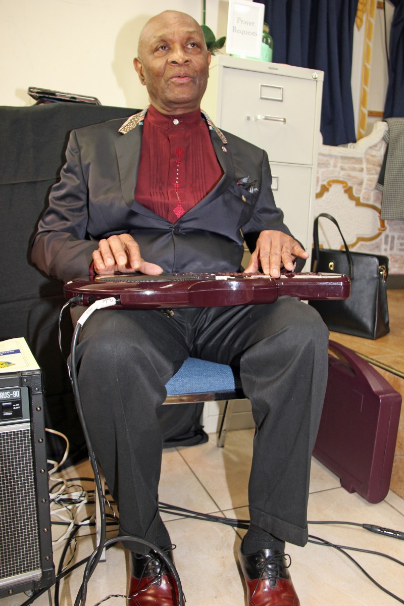 Pastor Cornelius Olive plays the Q-Cord, in March 2020, as the United Vincie Cultural Group of Brooklyn hosts a very successful Prayer Breakfast to aid SVG health institutions.