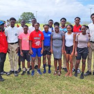 Kylla Herbert, (right) president South Jersey Caribbean Cultural and Development organization with the Charles E. Mills Secondary School's coaching staff and the athletes in February 2023