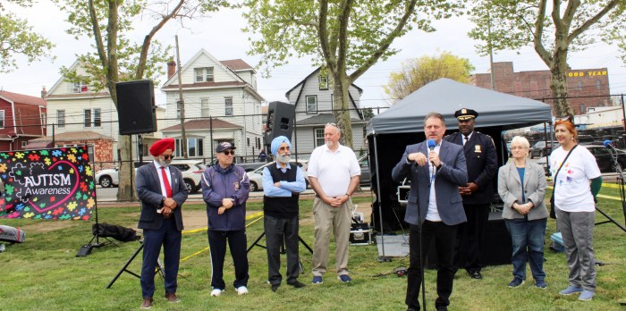 Senator Joseph P. Addabbo Jr. addressed participants at the second annual walk to bring awareness to Autism and Developmental Disabilities, last Saturday at Scooter Rizzuto Park/Smokey Oval, in Richmond Hill, Queens, as community partners look on, from left, Seik community leader, Anthony Lemma, Sheik community leader, Thomas Grech, Sen. Addabbo, at the microphone, Chief Williams, Councilmember Lynn Schulman, and Sherry Olgreo.