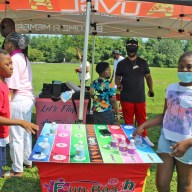 Campers enjoy a board game in Canarsie Park, Brooklyn to start a previous Summer Series Workshop, as part of the Guyana Folk Festival calendar of events.