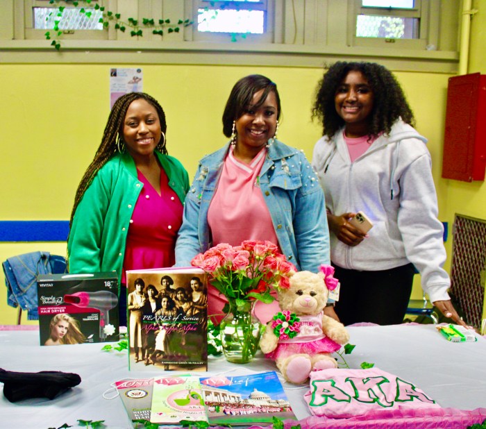 Alpha Kapp Alpha Sorority Inc, members Quin Welch, and Janai Jeter, with a student, handed out gift bags, during Sen. Kevin Parker's 15th Annual Prom Dress giveaway, at Samuel J. Tilden Educational Campus.