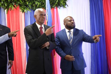 Edgard Leblanc Fils, left, and Smith Augustin prepare to pose for a group photo with the transitional council after it named Fils as its president in Port-au-Prince, Haiti, Tuesday, April 30, 2024. The transitional council will act as the country’s presidency until it can arrange presidential elections sometime before it disbands, which must be by February 2026.