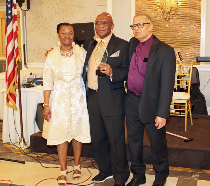 Dr. Nelson A. King, center, receives award from Don Sutherland, flanked by Dr. King's wife, Dofflyn.