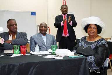 Pastor the Rev. Ronald Bailey, standing, with some members of the clergy at the Prayer Breakfast.