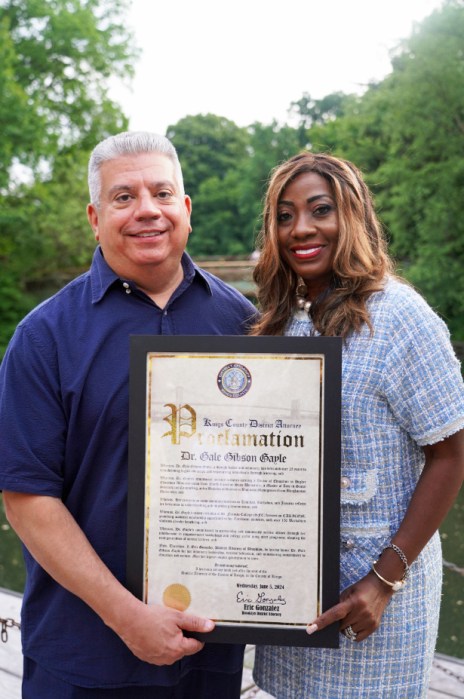 Brooklyn DA Eric Gonzalez presents a proclamation to Dr. Gale Gibson Gayle.