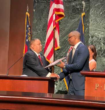Atlanta Councilman Michael Julian Bond presents the award to Albert “Al” Ely Edwards’s son, Jason K. Edwards.