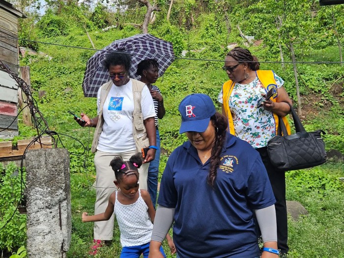 Dr. Judy Newton, Assemblywoman Jaime Williams, and Brenda Cox with a resident of St. Patrick’s, Grenada.