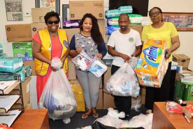 Assemblywoman Jaime Williams, second from left, flanked by Lions holding relief supplies for Grenada, Carriacou and Petite Martinique. Others in photo, from left: Jean Joseph, president of the Brooklyn Canarsie Lions, Tomi Marshall and Brenda Cox.