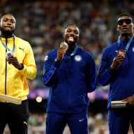 Gold medallist Noah Lyles of United States celebrates on the podium with silver medallist Kishane Thompson of Jamaica and bronze medallist Fred Kerley of United States.