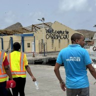A member of the UN Women’s deployment team is seen walking past a damaged building on Grenada’s sister island of Carriacou.