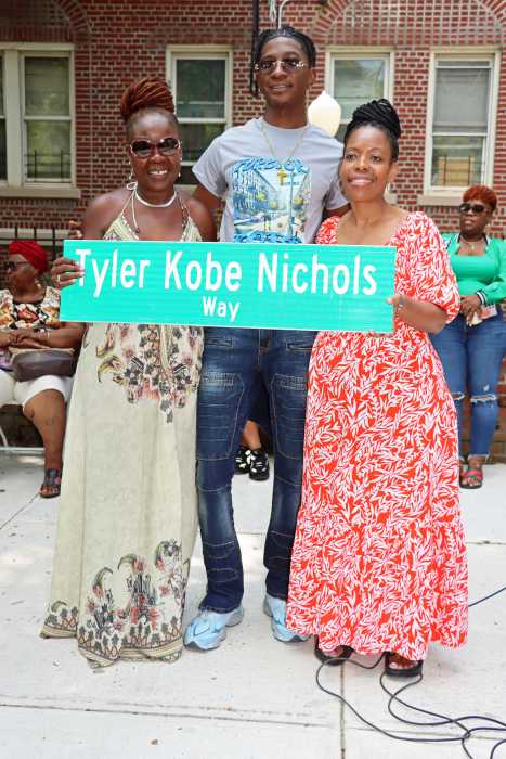 Council Member Rita Joseph, right, presents replica of Tyle Kobe Nichols Way to Sherma Chambers, flanked by Tyron Stearns, community coordinator for the 67th Precinct Clergy Council, popularly known as The GodSquad, who presided over the ceremony with Joseph.