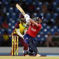 Sam Curran of England hits out for six runs watched by West Indies wicketkeeper Nicholas Pooran during the 3rd International t20 between the West Indies and England at Daren Sammy National Cricket Stadium on Nov. 14, 2024 in Gros Islet, Saint Lucia.