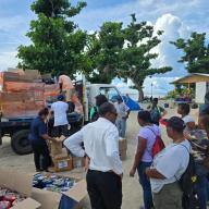 Assembly Member Jaime Williams, left, and her delegation delivering supplies to residents at a shelter on Carriacou.