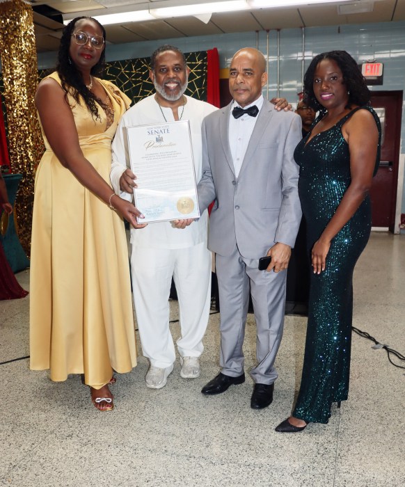 Sen. Kevin Parker, second from left, presents a proclamation to the Grenadian-American Ex-Teachers Association, flanked by Grenada Consul General to New York Michael Brizan, Jennifer Viechweg-Horsford, left, and Ketura Brizan.