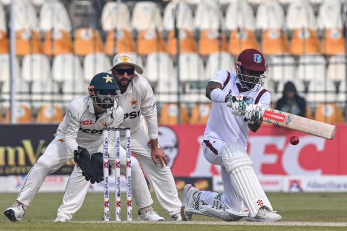 West Indies' Alick Athanaze (R) plays a shot during the third day of the first Test cricket match between Pakistan and West Indies at the Multan Cricket Stadium in Multan on Jan. 19, 2025.