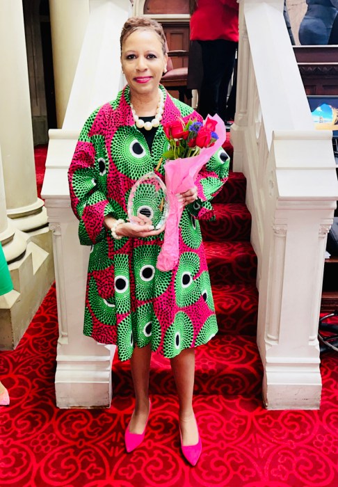 Adrienne Adams, Speaker of the New York City Council, proudly holds an award presented to her by Letitia James, New York Attorney General, in recognition of her exceptional leadership and unwavering commitment to keeping New Yorkers safe. This honor was given to her during the Women Empowerment Brunch at the Capitol Building's Assembly Chambers.