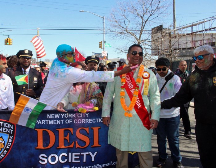 Queens Borough President Donovan Richards dabs colored powder on the face of Chair of the Phagwah Parade of New York Inc, and candidate for NY City Council, Romeo Hitlall during the 37th Phagwah Parade on Liberty Avenue, in Richmond Hill, Queens last Sunday.