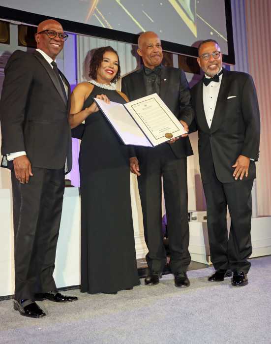 Sen. Audrey Marks displays proclamation received from Congresswoman Yvette D. Clarke, flanked by, (from left), Don Christian, UWI Vice Chancellor Sir Hilary Beckles and AFUWI Board Chair Dr. Cyrus McCalla.
