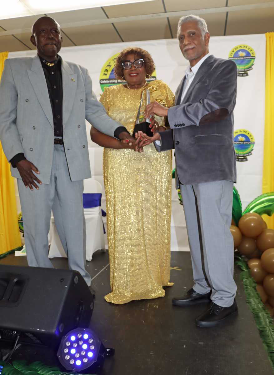 Dr. Frankie McIntosh, right, receives Induction Award from Mistress of Ceremonies and Former St. Vincent and the Grenadines Culture Minister Renee Baptiste, and Calypsonian and Culture Ambassador Cyril "Scorcher" Thomas.