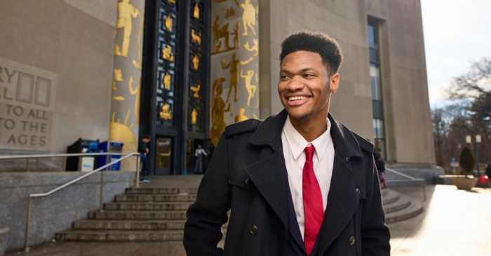 A CUNY student in front of the Brooklyn Public Library.