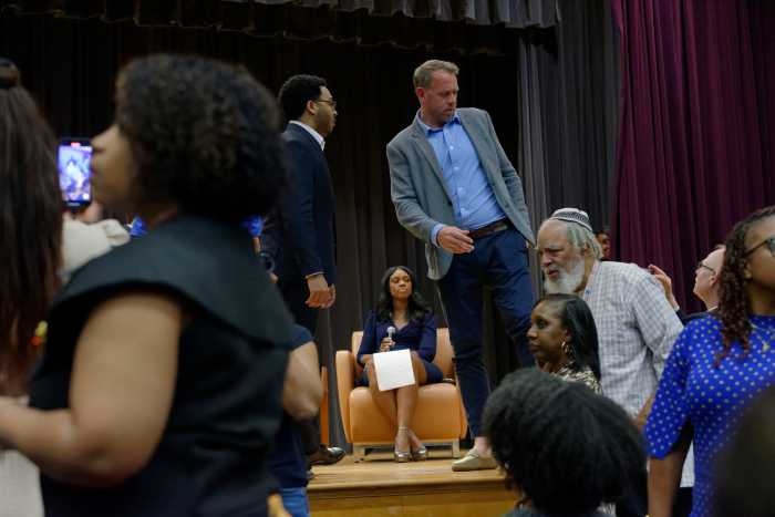 Officials react after protestors storm the stage while Former Governor Andrew Cuomo was seated for his interview at the Mayoral Forum on the Black Agenda at the Medgar Evers College on Wednesday, April 23, 2025.