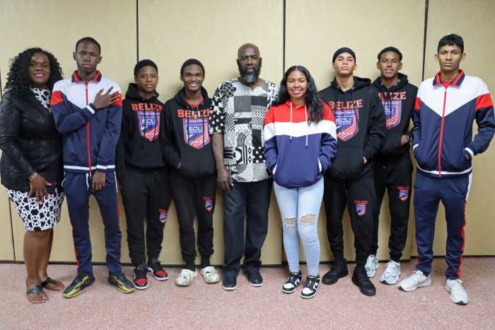 Erian Jang, Belize assistant coach and teacher, sixth from left, with James Cordice, fifth from left, coordinator of Belizean and Vincentian athletes at the Penn Relays; Kylla Herbert, coordinator of Team St. Kitts and Nevis; and Belizean athletes at reception at the Calabash Restaurant and Lounge in Philadelphia in April 2025.