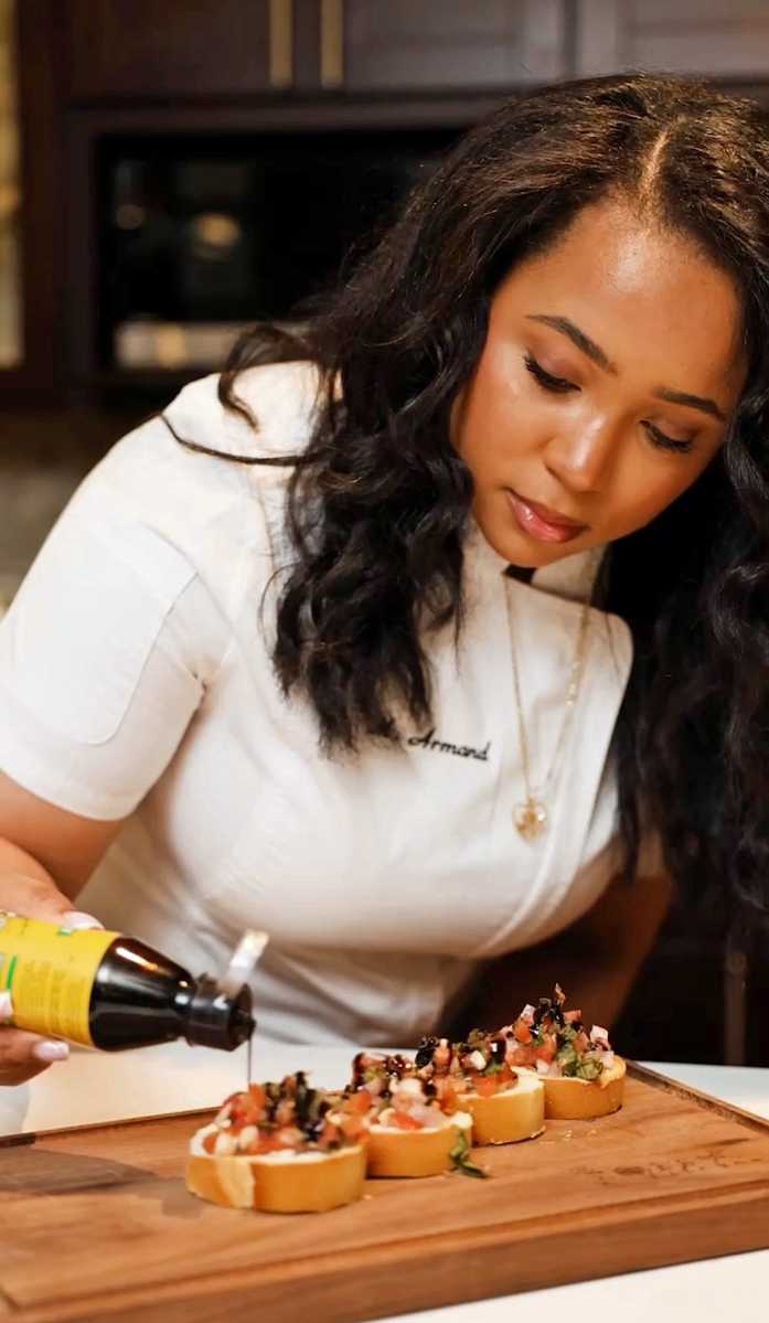 Private chef and public health student Marie Armand prepares entrées for a private catering event.