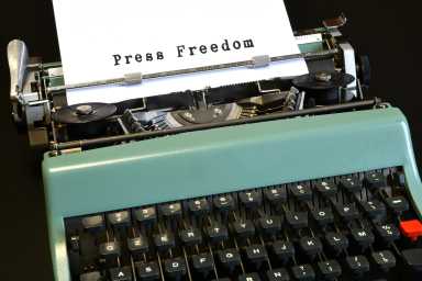 Close-up of a vintage typewriter with text “Press Freedom”