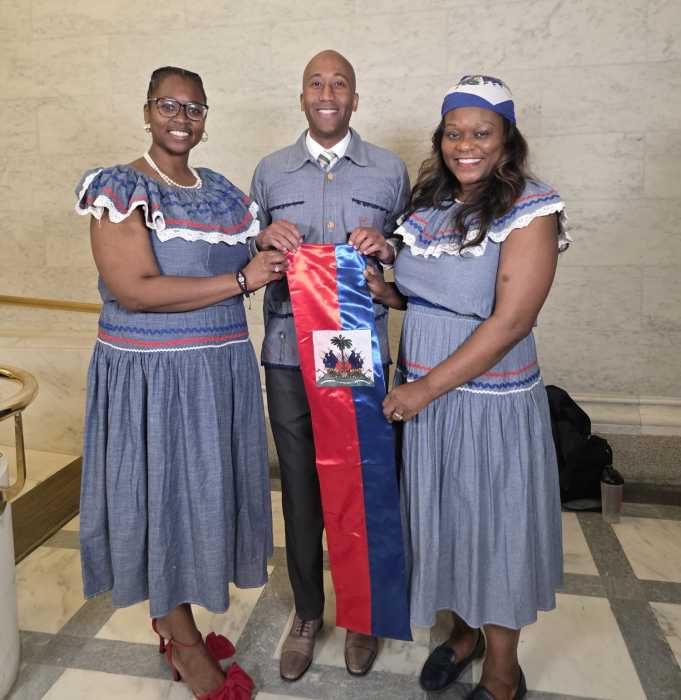 Haitian delegation displays the Haitian Flag: Assemblywoman Rodneyse Bichotte Hermelyn, right, with Assemblywoman Phara Soffraunt Forrest and Assemblyman Clyde Vanel.