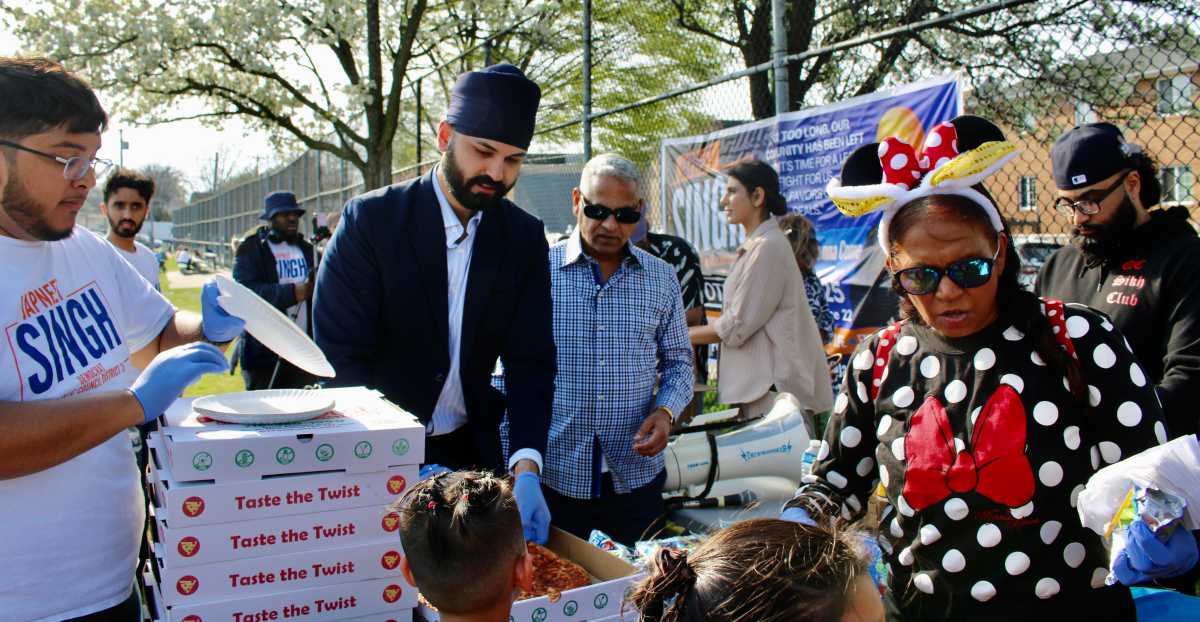 Japneet Singh, candidate for New York City Council District 28, second from left wearing his religious Sikh turban, as he served the long line of kids at Police Officer Edward Byrne Park, in South Ozone Park, at an Easter Egg Hunt on April 19, 2025.