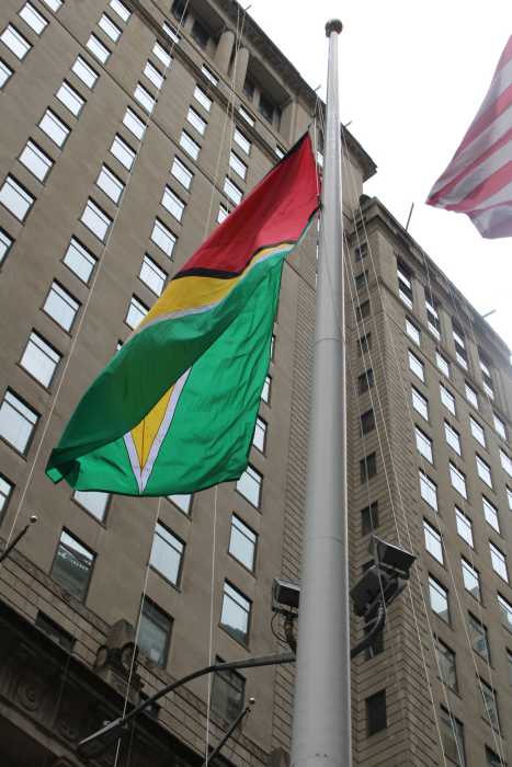 Guyana's Golden Arrowhead flag of freedom flying with pride and honor above historic Bowling Green Square, Manhattan in honor of the nation's 59th Anniversary of Independence, celebrated on May 23, 2025.