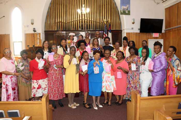 The Rev. Roger Jackson, back row, with mothers displaying their gifts.