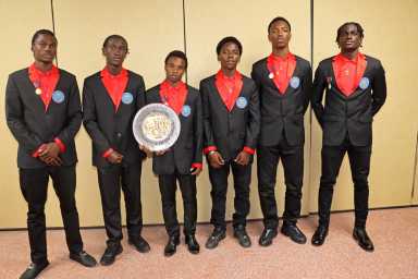 CEMSS boys' athletes display plaque won in 4x400m heat.