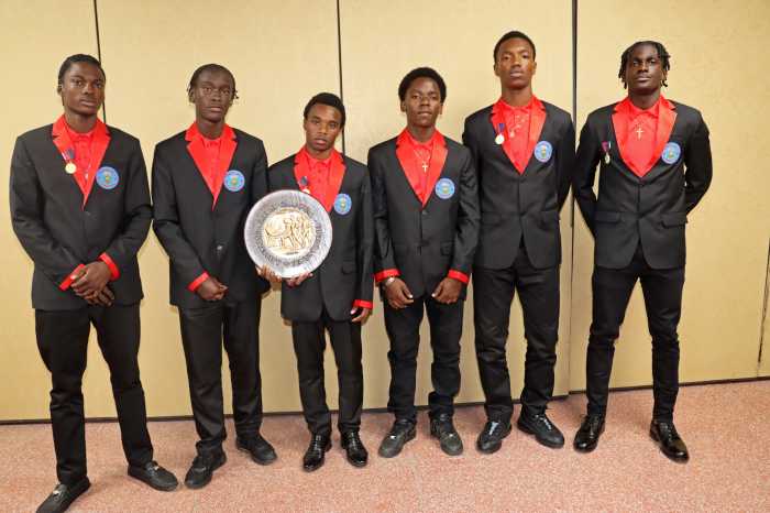 CEMSS boys' athletes display plaque won in 4x400m heat.
