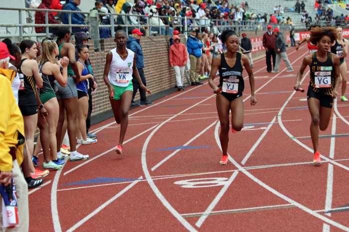 Malia Roberts (YK, left) starts 4x400m for Emmanuel High School Mesopotamia.