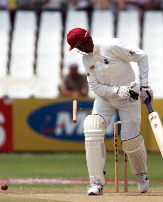 Courntey Walsh looks back at his wicket as he is bowled during the West Indies' second innings of the third test match at the Kings Mead Cricket grounds in Durban Dec.29, 1998. West Indies were all out for 259.