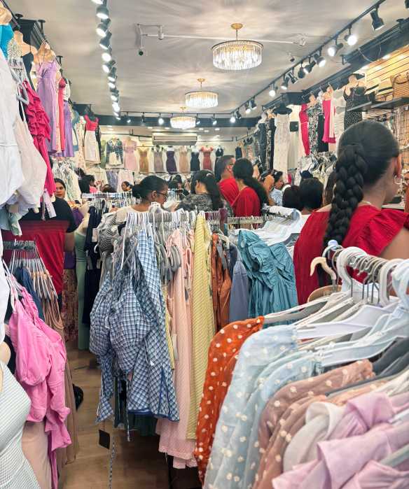 Shoppers browse racks at Knockout Styles, now open seven days a week. The updated boutique aims to serve a multigenerational clientele with fresh fashion at familiar prices.