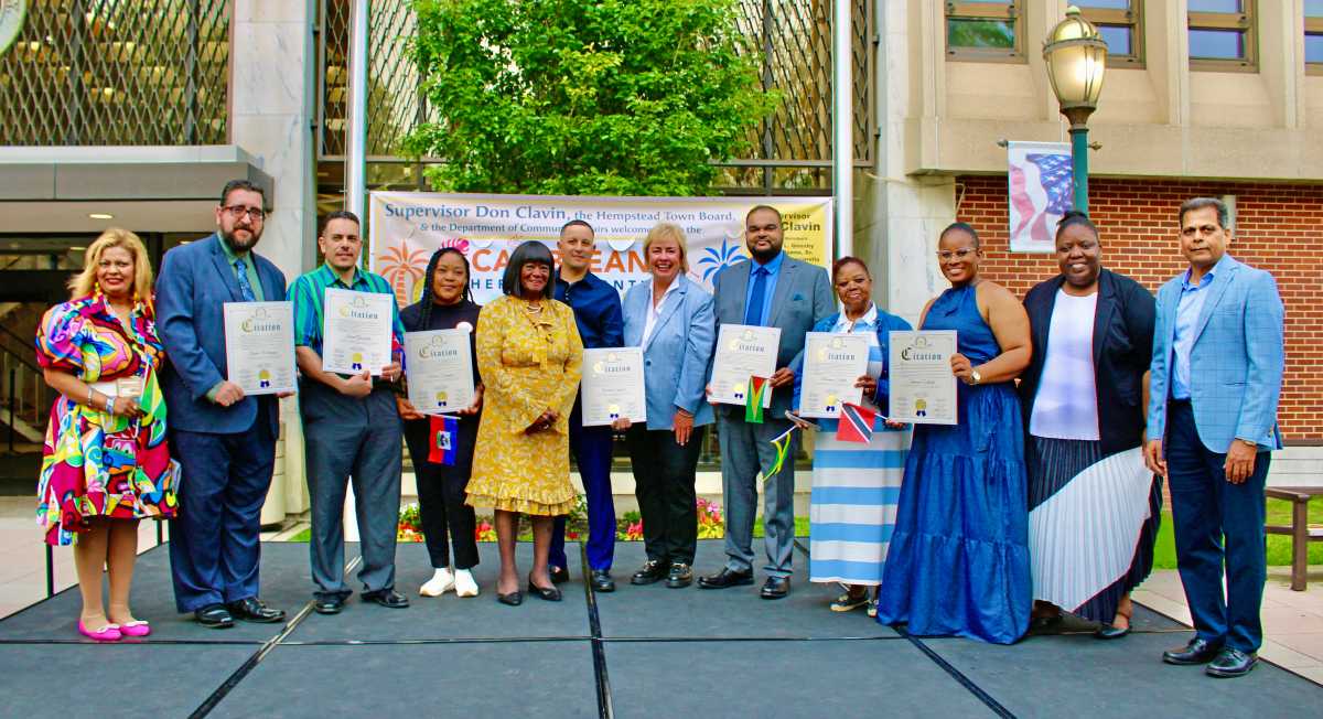 Organizers, Sherry Williams, and Trudy King, joined honorees, (no particular order) Israel Gonzalez, Gabriel Espinal, Marie Durand, Zahid Razak, Norman Fraser, Shivani Collado, and Xavier Rodrigues. and legislators, Dorothy L. Goosby, fifth from left, (for which the Plaza was named), seventh from left, Town Clerk Kater Murray, and Zahid Syed, at end, at the Hempstead Town Board & the Department of Community Affairs Caribbean Heritage Month Celebration on May 6, 2025.