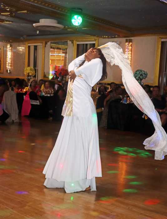 Sharell Peters, Yvonne Peters's niece, dances during the retirement party.