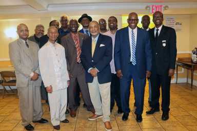Pastor Rev. Roger Jackson, second from right, front, with fathers at reception after Father's Day Service.