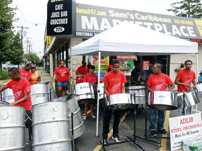 The Adlib Steel Orchestra performing in front of Sam’s Caribbean Marketplace in Hempstead, Long Island.