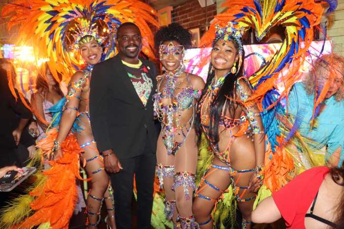 St. Kitts and Nevis Minister of Culture Samal Duggins, second from left, with masqueraders.