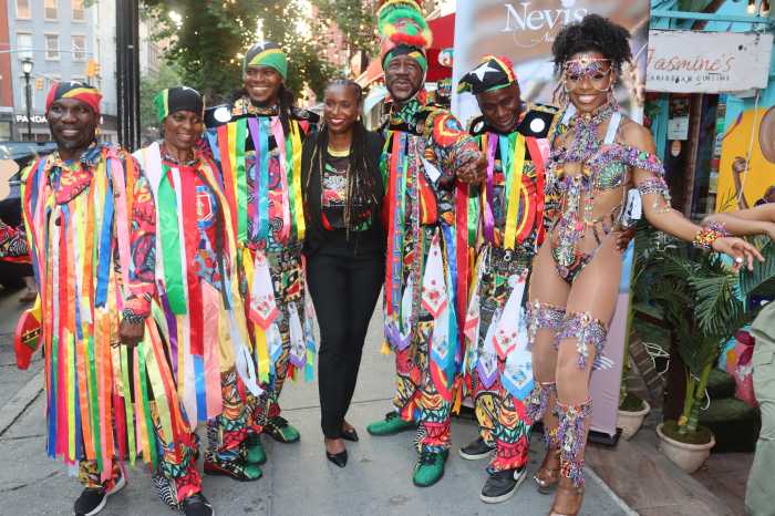 Traditional and regular masqueraders outside Jasmine's Cuisine in Manhattan.