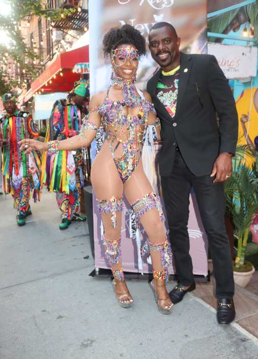 Minister of Culture Samal Duggins with masquerader Carla Bradshaw, grand daughter of the late St. Kitts Premier Robert Bradshaw, outside Jasmine's Cuisine in Manhattan.